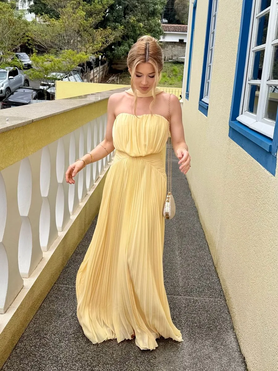Nayara Lamari com vestido amarelo em registro de evento